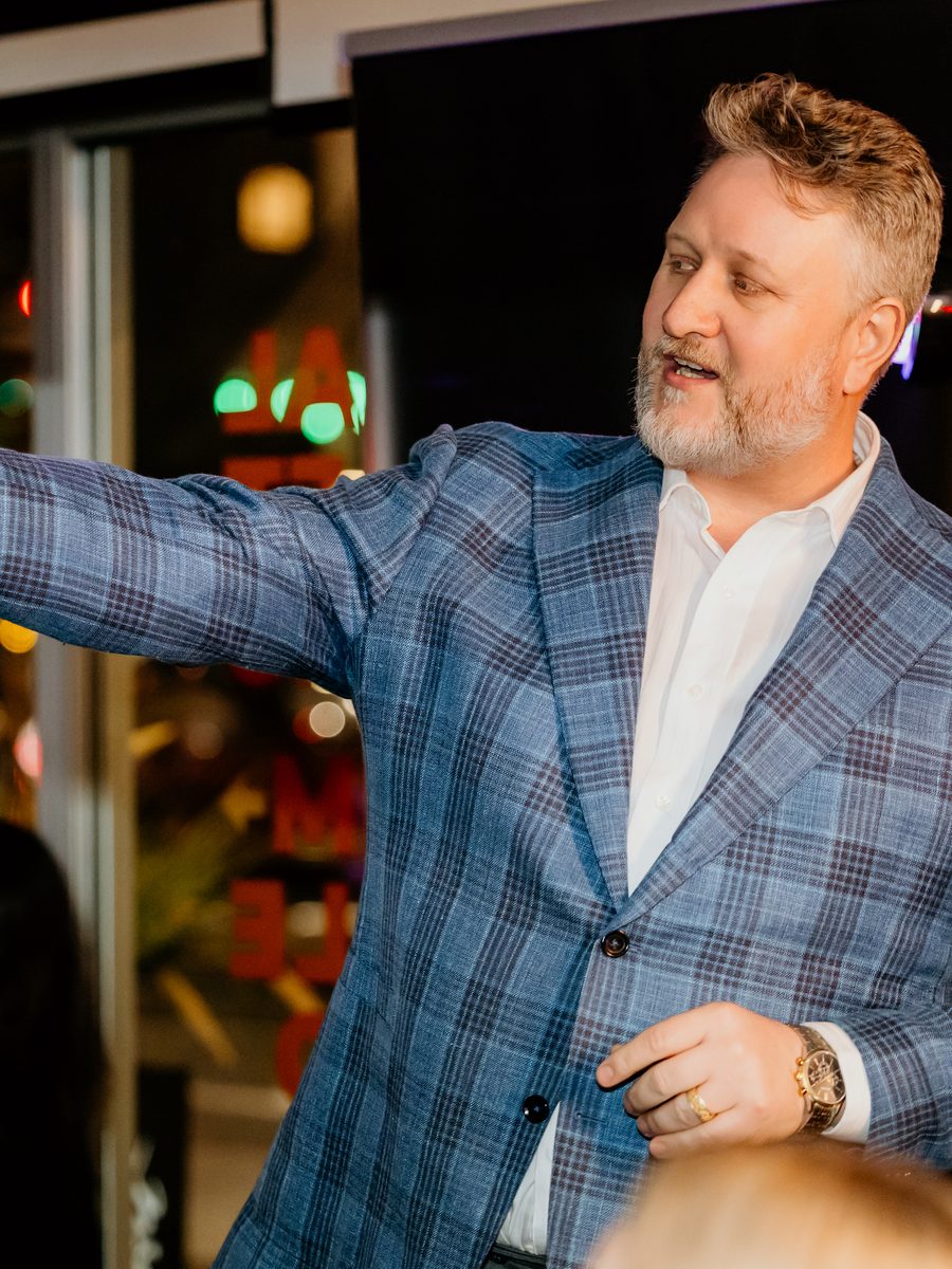 Zane speaking at an evening event